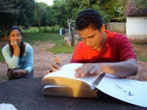 A young man in Paraguay reads his Braille Bible