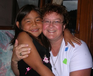 Kathy Bender poses with a child blessed through the BC Mission Boat Society's ministry.