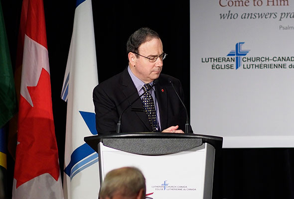 President Robert Bugbee leads the Convention in prayer for Moncton.