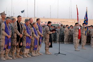 Capt. Padre Ristau (in black stole) participates in a ramp ceremony for Private (Pte) Sébastien Courvey, who was killed in action on July 16, 2009 while conducting operations in the Panjwai District of Afghanistan.