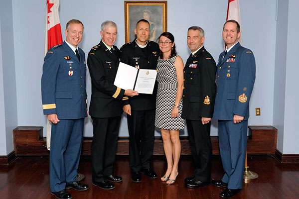 Captain Harold Ristau, CAF Recognition Program recipient, with his spouse Elise Ristau, receives a Chief of the Defence Staff Commendation from Vice Chief of the Defence Staff Lieutenant-General Guy Thibault, accompanied by Major General David Millar, Chief Warrant Officer Pierre Marchand, and Chief Warant Officer Kevin West, at the Sergeant's mess in Ottawa on May 31, 2014