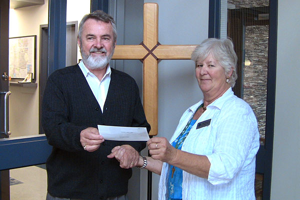 NAme presents Dr. Neitzel a cheque.