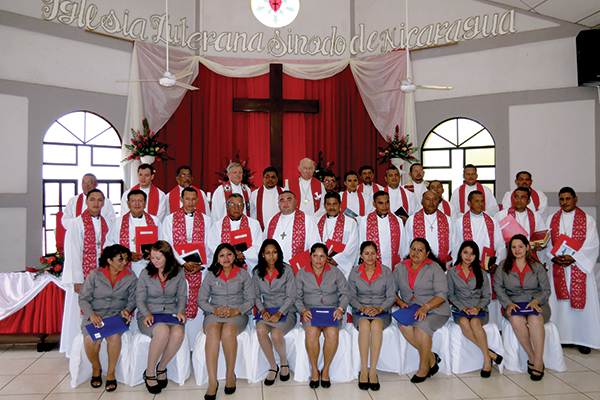 Newly consecrated deaconesses (front row) and newly ordained pastors (middle row) pose for a picture following the service. In the back row are pastors who took part in the service, including Rev. Ed Auger, ILSN President Marvin Donaire, and LCC President Emeritus Ralph Mayan (left to right, beneath the cross).