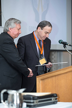 President Bugbee thanks President Zabel, after the East District presents LCC with a cheque. (Photo: Chris Bruer)