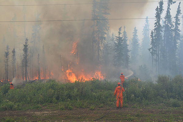 Firefighters fighting fire in northern Saskatchewan on July 5.
