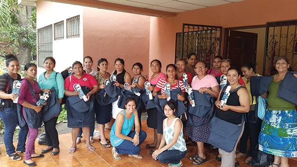 Nicaraguan deaconesses pose with new laptop bags and surge protectors.