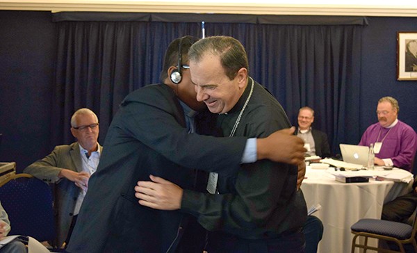 LCC President Bugbee (right) congratulates ILSN President Donaire after the Nicaraguan church was welcomed into membership in the ILC.