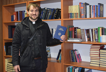 SELCU Vice President Schewtschenko displays some of the books in the SELCU seminary's library.
